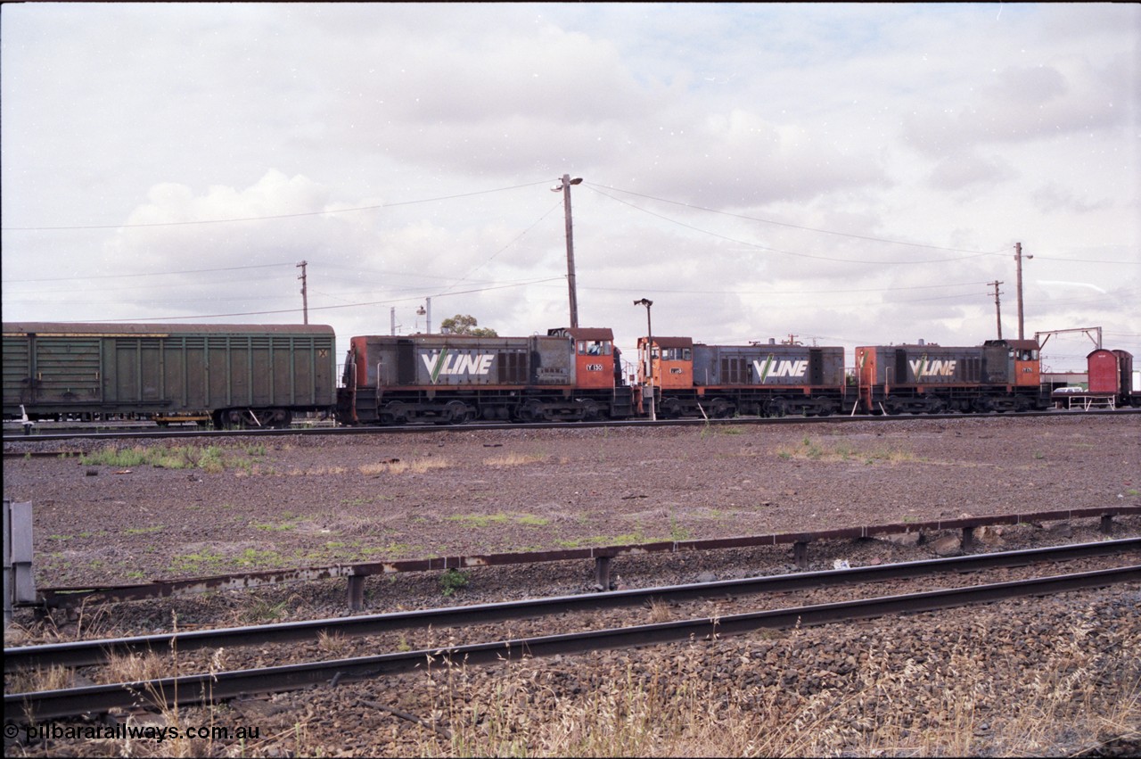 177-03
Tottenham Yard, view from standard gauge mainline of broad gauge Clyde Engineering EMD model G6B, V/Line shunt locomotives of the Y class, Y 130 serial 65-396 with a green louvre van and Y 118 serial 63-308 and Y 171 serial 68-591 as they go about Saturday morning shunting duties. In the final years of V/Line operation, the Y class were operated in pairs to shunt Tottenham Yard.
Keywords: Y-class;Y130;Clyde-Engineering-Granville-NSW;EMD;G6B;65-396;