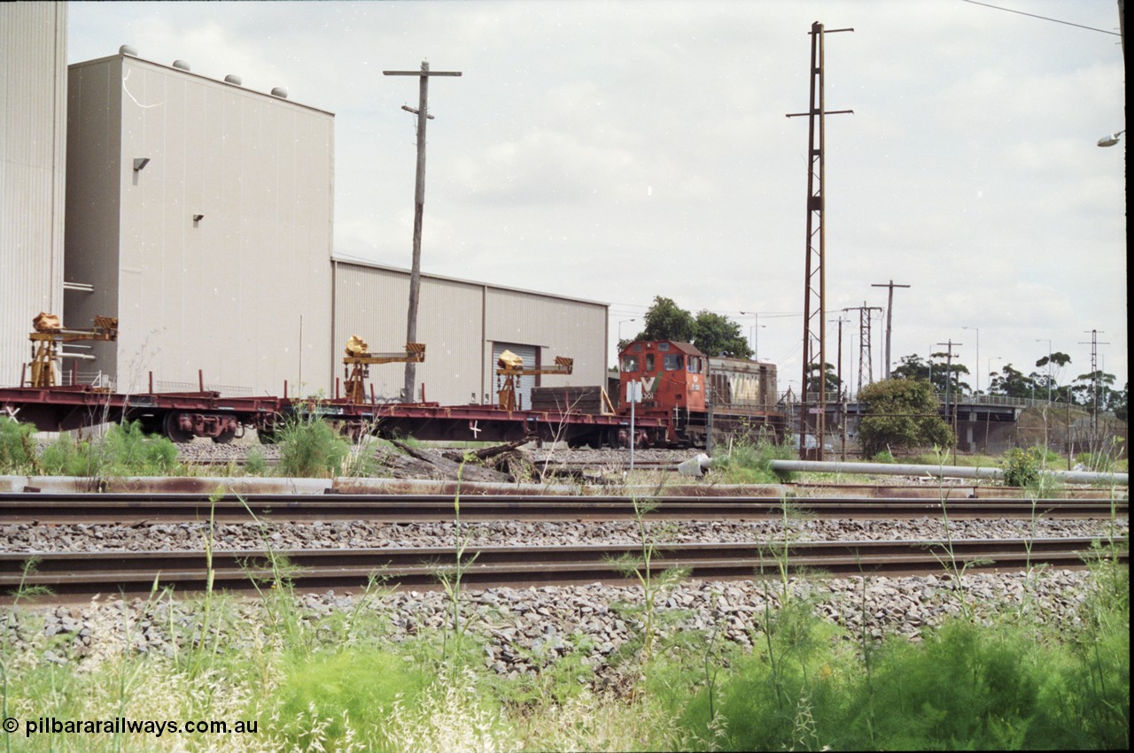 177-09
Newport Junction, V/Line broad gauge shunt locomotive Y class Y 130 Clyde Engineering EMD model G6B serial 65-396 leads a rail recovery train of VZRF class bogie welded rail transport waggons, along the Newport - Sunshine Loop Line, Melbourne Road overpass is visible, the Spotswood Reclamation Yards are to the right if frame.
Keywords: Y-class;Y130;Clyde-Engineering-Granville-NSW;EMD;G6B;65-396;