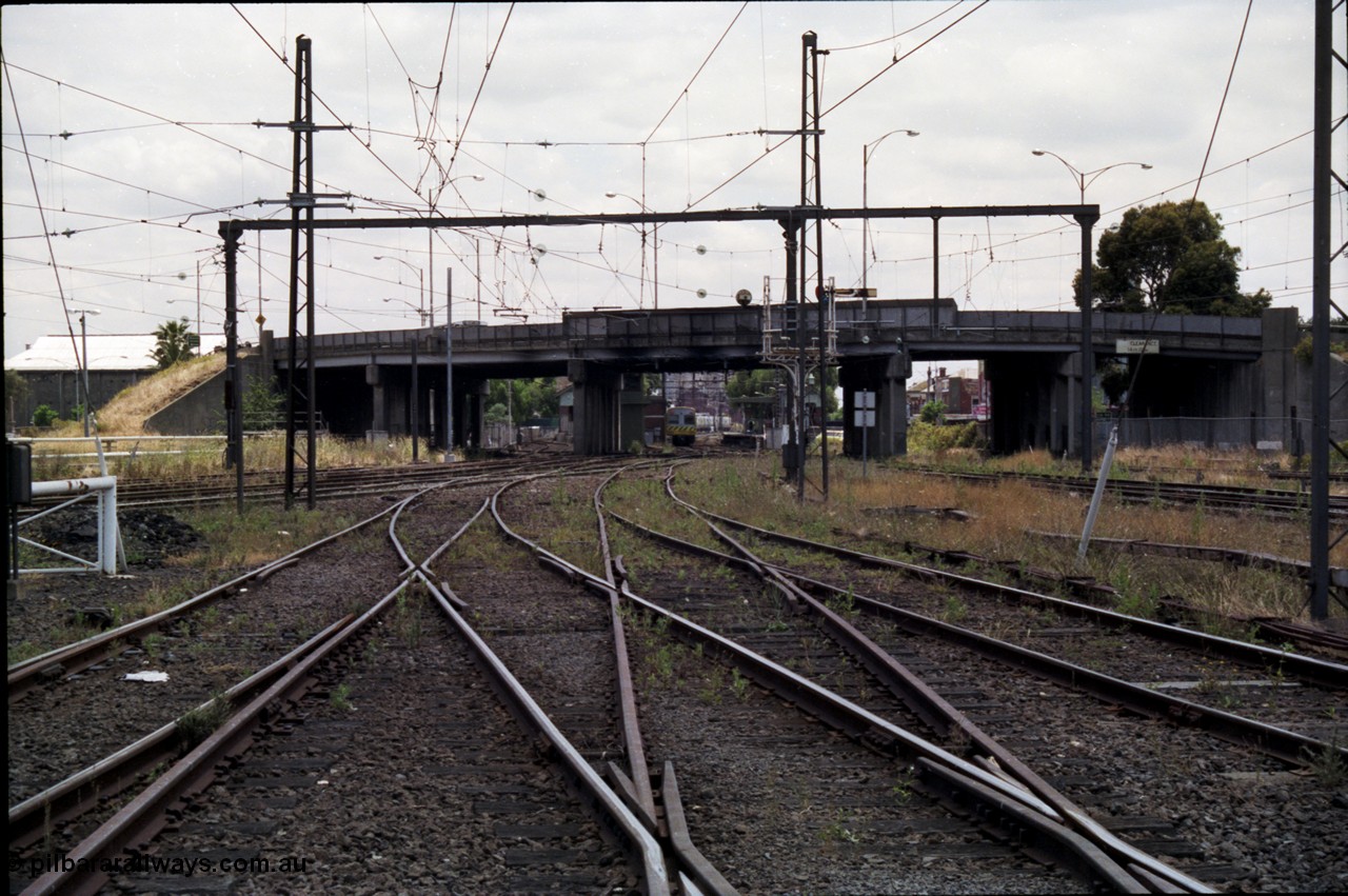 177-10
Newport station and yard overview taken from the workshops roads, Williamstown lines are at the right, I'm standing at the Newport Workshops No.1 and No.2 double track junction, the lines to Geelong are on the left beyond the white gate, a Comeng electric set is at the platform with the overbridge carrying Melbourne Road.
