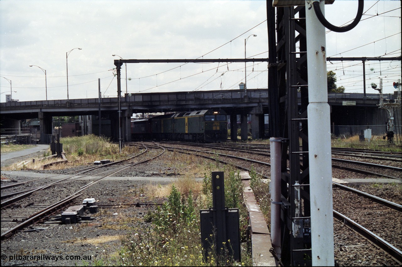 177-13
Newport, looking towards Melbourne, V/Line broad gauge down goods train 9169 creeps under the Melbourne Road overpass behind a pair of Australian National BL class locomotives, with a V/Line S and X class rounding out the motive power.
Keywords: BL-class;BL27;Clyde-Engineering-Rosewater-SA;EMD;JT26C-2SS;88-1011;