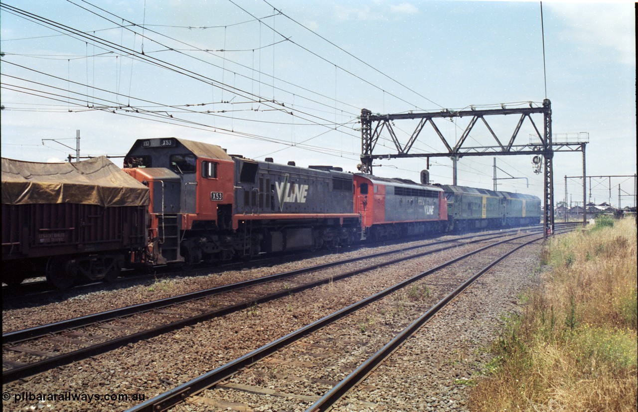 177-15
Newport, V/Line broad gauge down goods train to Adelaide 9169 with the impressive quad combo of a pair of Australian National BL class locomotives BL 27 Clyde Engineering EMD model JT26C-2SS serial 83-1011 and class leader BL 26 'Bob Hawke' serial 83-1010 and V/Line S class S 313 'Alfred Deakin' Clyde Engineering EMD model A7 serial 61-230 and V/Line X class loco X 53 with serial 75-800 a Clyde Engineering Rosewater SA built EMD model G26C round the curve on the Geelong line with the workshops in the background.
Keywords: X-class;X53;Clyde-Engineering-Rosewater-SA;EMD;G26C;75-800;