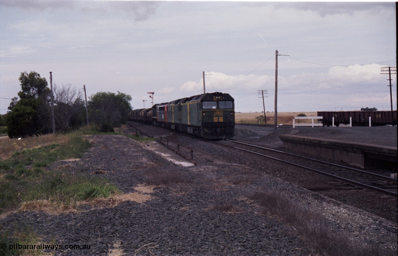 177-16
Gheringhap, down V/Line broad gauge goods train to Adelaide 9169 drifts to a stand to change the electric staff for a train order behind Australian National BL class locomotives BL 27 Clyde Engineering EMD model JT26C-2SS serial 83-1011 and class leader BL 26 'Bob Hawke' serial 83-1010 and V/Line S class S 313 'Alfred Deakin' Clyde Engineering EMD model A7 serial 61-230 and X class X 53 Clyde Engineering EMD model G26C serial 75-800.
Keywords: BL-class;BL27;Clyde-Engineering-Rosewater-SA;EMD;JT26C-2SS;88-1011;