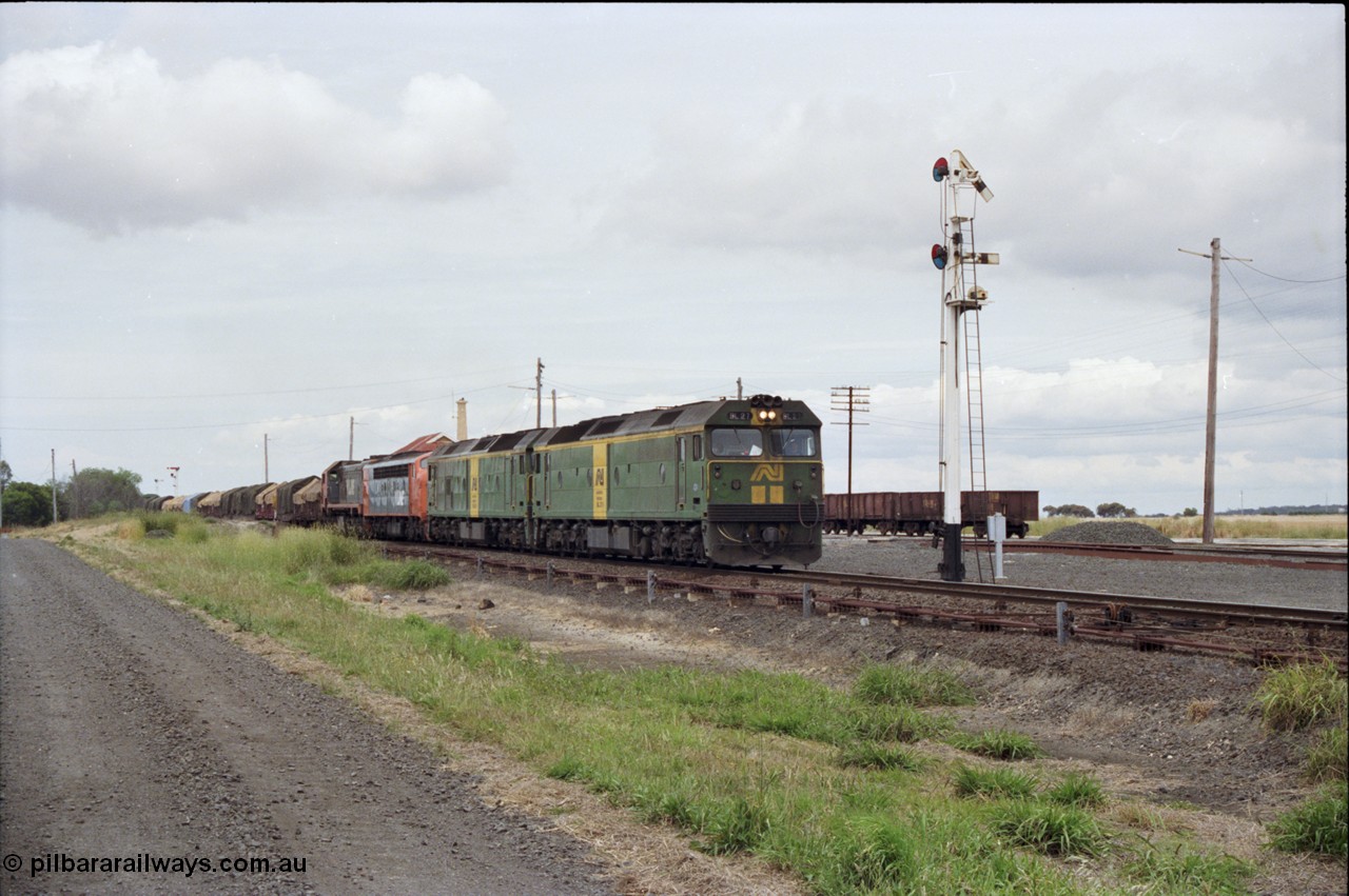 177-24
Gheringhap, down V/Line broad gauge goods train to Adelaide 9169 gets under way towards Ararat via Cressy with semaphore signal post 4 pulled off for the Cressy line, with power of the quad combo of a pair of Australian National BL class locomotives BL 27 Clyde Engineering EMD model JT26C-2SS serial 83-1011 and class leader BL 26 'Bob Hawke' serial 83-1010 and V/Line S class S 313 'Alfred Deakin' Clyde Engineering EMD model A7 serial 61-230 and X class X 53 Clyde Engineering EMD model G26C serial 75-800, BL 27 had Paul Keating drawn on the LHS cab as it was just after he'd taken the Labor Party leadership and the Prime Ministership off Bob Hawke.
Keywords: BL-class;BL27;Clyde-Engineering-Rosewater-SA;EMD;JT26C-2SS;88-1011;