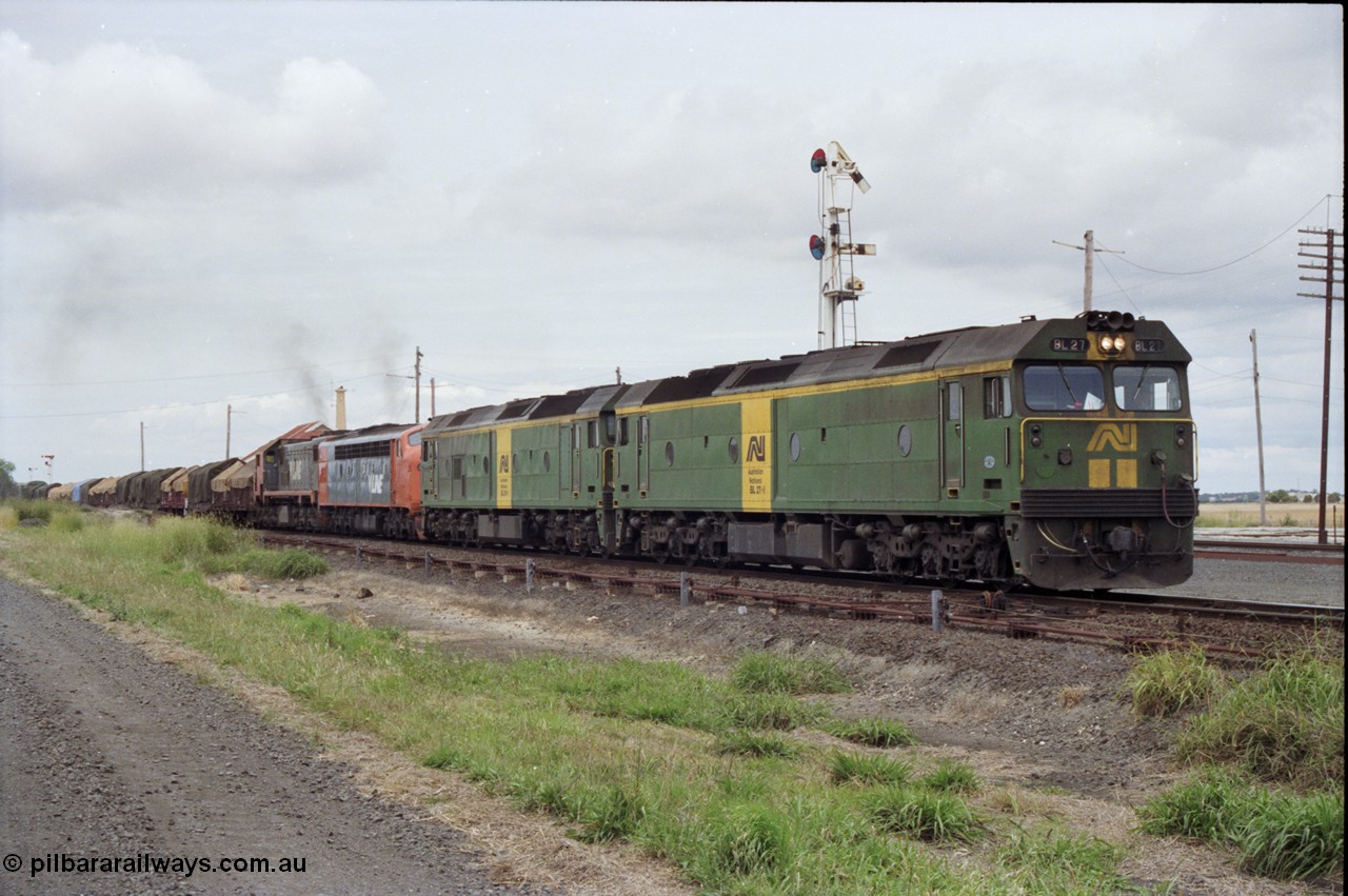 177-25
Gheringhap, down V/Line broad gauge goods train to Adelaide 9169 gets under way towards Ararat via Cressy with semaphore signal post 4 pulled off for the Cressy line, with power of the quad combo of a pair of Australian National BL class locomotives BL 27 Clyde Engineering EMD model JT26C-2SS serial 83-1011 and class leader BL 26 'Bob Hawke' serial 83-1010 and V/Line S class S 313 'Alfred Deakin' Clyde Engineering EMD model A7 serial 61-230 and X class X 53 Clyde Engineering EMD model G26C serial 75-800, BL 27 had Paul Keating drawn on the LHS cab as it was just after he'd taken the Labor Party leadership and the Prime Ministership off Bob Hawke.
Keywords: BL-class;BL27;Clyde-Engineering-Rosewater-SA;EMD;JT26C-2SS;88-1011;