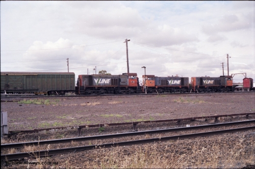177-03
Tottenham Yard, view from standard gauge mainline of broad gauge Clyde Engineering EMD model G6B, V/Line shunt locomotives of the Y class, Y 130 serial 65-396 with a green louvre van and Y 118 serial 63-308 and Y 171 serial 68-591 as they go about Saturday morning shunting duties. In the final years of V/Line operation, the Y class were operated in pairs to shunt Tottenham Yard.
Keywords: Y-class;Y130;Clyde-Engineering-Granville-NSW;EMD;G6B;65-396;