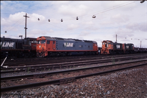 177-04
Tottenham Yard, view from the middle of the yard of broad gauge Clyde Engineering EMD model G6B V/Line shunt locomotives of the Y class, Y 130 serial 65-396 with a green louvre van and Y 118 serial 63-308 and Y 171 serial 68-591 as they go about Saturday morning shunting duties. In the final years of V/Line operation, the Y class were operated in pairs to shunt Tottenham Yard.
Keywords: G-class;G536;Clyde-Engineering-Somerton-Victoria;EMD;JT26C-2SS;88-1266;