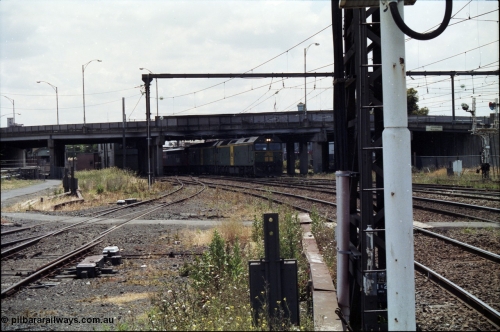 177-13
Newport, looking towards Melbourne, V/Line broad gauge down goods train 9169 creeps under the Melbourne Road overpass behind a pair of Australian National BL class locomotives, with a V/Line S and X class rounding out the motive power.
Keywords: BL-class;BL27;Clyde-Engineering-Rosewater-SA;EMD;JT26C-2SS;83-1011;