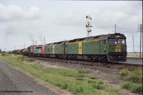 177-25
Gheringhap, down V/Line broad gauge goods train to Adelaide 9169 gets under way towards Ararat via Cressy with semaphore signal post 4 pulled off for the Cressy line, with power of the quad combo of a pair of Australian National BL class locomotives BL 27 Clyde Engineering EMD model JT26C-2SS serial 83-1011 and class leader BL 26 'Bob Hawke' serial 83-1010 and V/Line S class S 313 'Alfred Deakin' Clyde Engineering EMD model A7 serial 61-230 and X class X 53 Clyde Engineering EMD model G26C serial 75-800, BL 27 had Paul Keating drawn on the LHS cab as it was just after he'd taken the Labor Party leadership and the Prime Ministership off Bob Hawke.
Keywords: BL-class;BL27;Clyde-Engineering-Rosewater-SA;EMD;JT26C-2SS;83-1011;