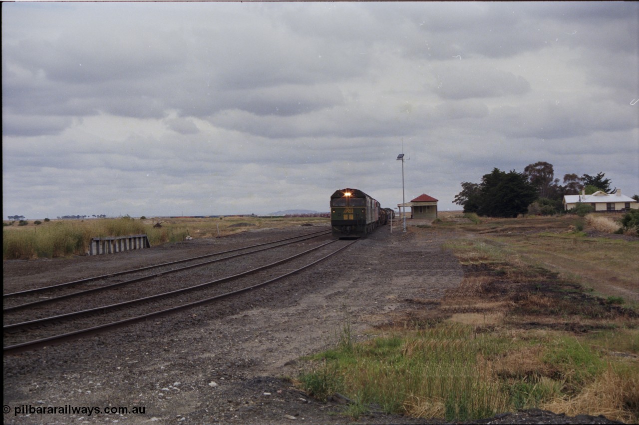 178-02
Cressy, the peace of this once former four way junction station is shattered as V/Line down broad gauge goods train 9169 to Adelaide powers past the station building along the crossing loop behind a quad of screaming EMD 2 stroke locomotives, an Australian National BL class is leading the charge.
