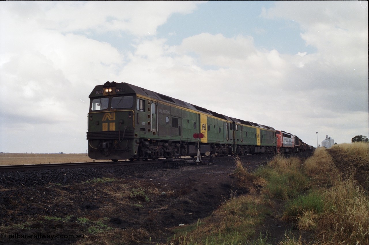 178-09
Tatyoon, down V/Line broad gauge goods train to Adelaide 9169 powers through the trailable points at the western end of the loop heading towards Ararat with the quad combo of a pair of Australian National BL class locomotives BL 27 Clyde Engineering EMD model JT26C-2SS serial 83-1011 and class leader BL 26 'Bob Hawke' serial 83-1010 and V/Line S class S 313 'Alfred Deakin' Clyde Engineering EMD model A7 serial 61-230 and X class X 53 Clyde Engineering EMD model G26C serial 75-800, BL 27 had Paul Keating drawn on the LHS cab as it was just after he'd taken the Labor Party leadership and the Prime Ministership off Bob Hawke.
Keywords: BL-class;BL27;Clyde-Engineering-Rosewater-SA;EMD;JT26C-2SS;88-1011;