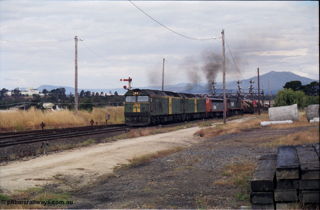 178-16
Ararat, track view looking east as V/Line broad gauge goods train 9169 to Adelaide powers up along the mainline off the Portland line under the signal gantry with semaphore signal post 4 pulled off behind Australian National BL class locomotives BL 27 Clyde Engineering EMD model JT26C-2SS serial 83-1011 and class leader BL 26 'Bob Hawke' serial 83-1010 and V/Line S class S 313 'Alfred Deakin' Clyde Engineering EMD model A7 serial 61-230 and X class X 53 Clyde Engineering EMD model G26C serial 75-800, taken from the former Works and Cattle Sidings area, the Aradale Asylum is in the background.
Keywords: BL-class;BL27;Clyde-Engineering-Rosewater-SA;EMD;JT26C-2SS;88-1011;