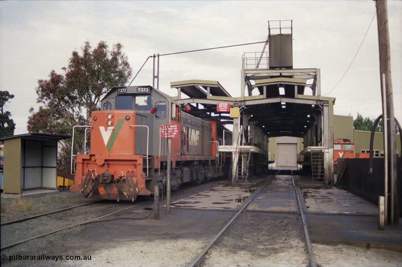 178-19
Ballarat East loco depot fuel and sanding point, V/Line broad gauge T class T 373 Clyde Engineering EMD model G8B serial 64-328 stabled over the weekend coupled to an X class, an N class lurks in the background.
Keywords: T-class;T373;Clyde-Engineering-Granville-NSW;EMD;G8B;64-328;