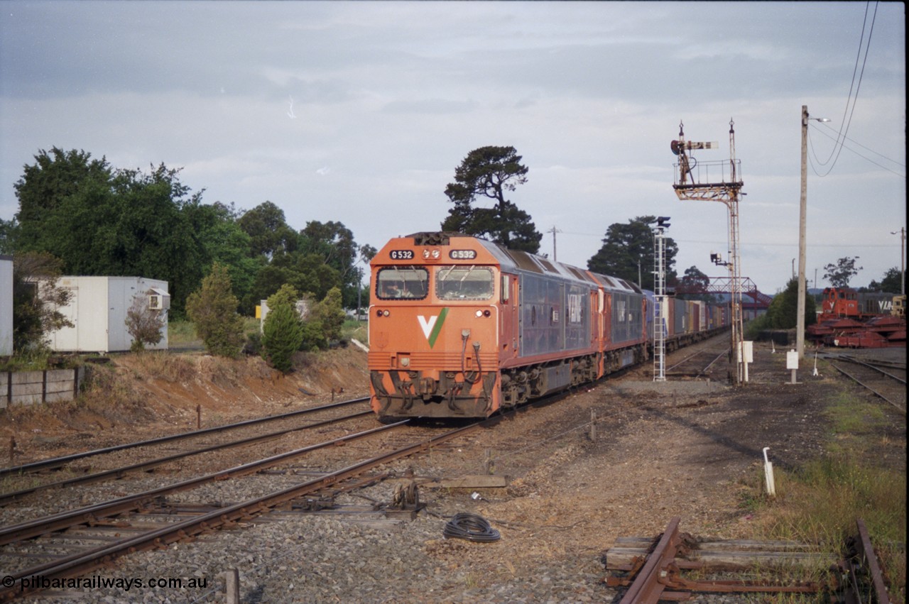 178-23
Ballarat East, track view looking east towards Warrenheip, V/Line broad gauge down goods train under the power of G class G 532 Clyde Engineering EMD model JT26C-2SS serial 88-1262 and a sister are about to diverge from the down mainline to No.1 Rd, the disc on signal post 3 is pulled off for the move, new electric light signal post at the end of the former Eureka line has its head turned away from the track until commissioned, Ballarat East loco depot is on the right.
Keywords: G-class;G532;Clyde-Engineering-Somerton-Victoria;EMD;JT26C-2SS;88-1262;