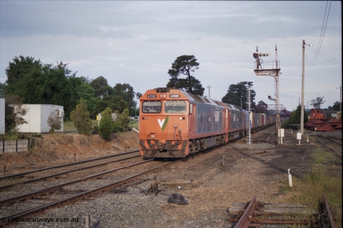 178-23
Ballarat East, track view looking east towards Warrenheip, V/Line broad gauge down goods train under the power of G class G 532 Clyde Engineering EMD model JT26C-2SS serial 88-1262 and a sister are about to diverge from the down mainline to No.1 Rd, the disc on signal post 3 is pulled off for the move, new electric light signal post at the end of the former Eureka line has its head turned away from the track until commissioned, Ballarat East loco depot is on the right.
Keywords: G-class;G532;Clyde-Engineering-Somerton-Victoria;EMD;JT26C-2SS;88-1262;