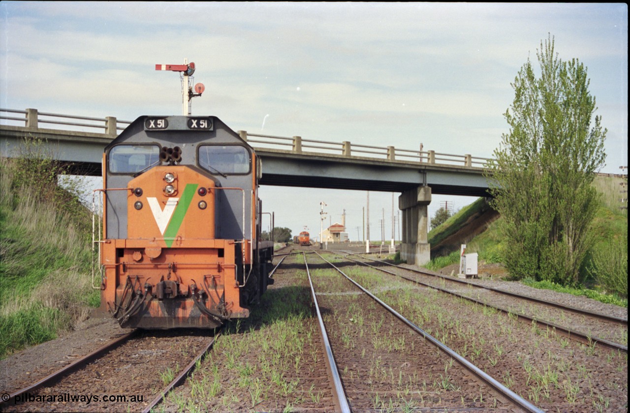 179-20
Gheringhap, station yard overview looking east from the Ballarat line and Siding C, the line to Maroona is on the right, in the back ground semaphore signal post 4 is pulled of for down goods train 9169 to depart, V/Line broad gauge X class locomotive X 51 Clyde Engineering EMD model G26C serial 75-798 is awaiting light engines from Geelong to come and retrieve it.
Keywords: X-class;X51;Clyde-Engineering-Rosewater-SA;EMD;G26C;75-798;