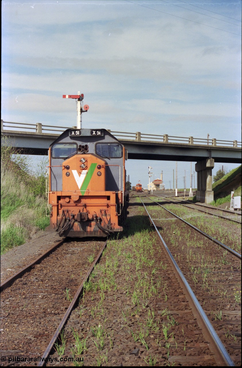 179-21
Gheringhap, station yard overview looking east from the Ballarat line and Siding C, the line to Maroona is on the right, in the back ground semaphore signal post 4 is pulled of for down goods train 9169 to depart, V/Line broad gauge X class locomotive X 51 Clyde Engineering EMD model G26C serial 75-798 is awaiting light engines from Geelong to come and retrieve it.
Keywords: X-class;X51;Clyde-Engineering-Rosewater-SA;EMD;G26C;75-798;