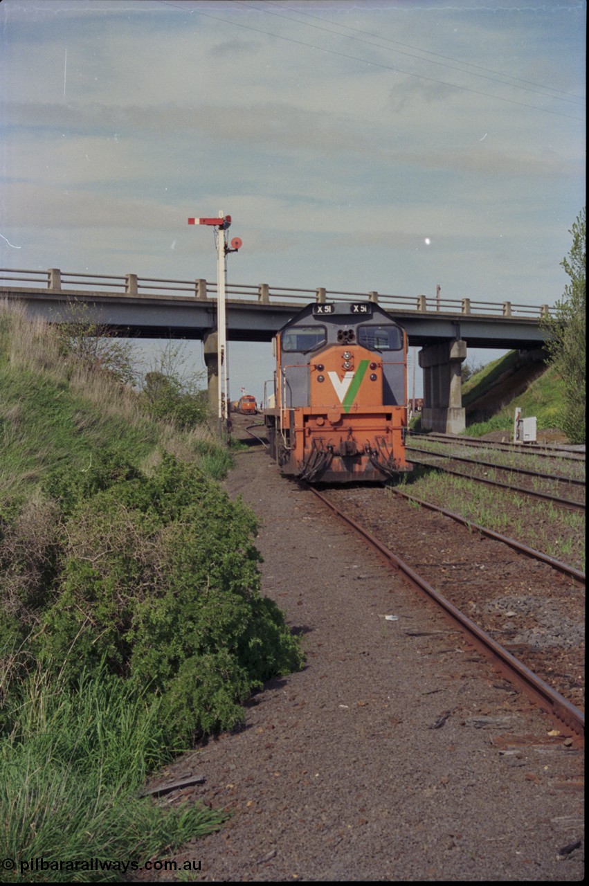 179-22
Gheringhap, station yard overview looking east from Siding C, past V/Line broad gauge X class locomotive X 51 Clyde Engineering EMD model G26C serial 75-798 that is awaiting light engines from Geelong to come and retrieve it and semaphore signal post 5, down goods train 9169 is about to depart in the background.
Keywords: X-class;X51;Clyde-Engineering-Rosewater-SA;EMD;G26C;75-798;