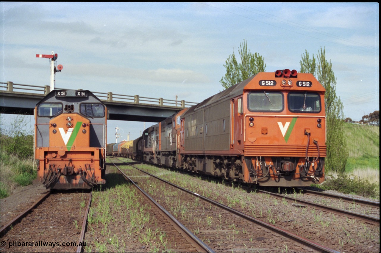 179-24
Gheringhap, V/Line broad gauge goods train 9169 to Adelaide behind G class G 512 Clyde Engineering EMD model JT26C-2SS serial 84-1240 and C classes C 510 Clyde Engineering EMD model GT26C serial 76-833 and C 509 serial 76-832 creeps along the Maroona Line under the Midland Highway overpass as the 2nd person has just climbed aboard G 512 and head home to Dimboola, X class X 51 Clyde Engineering EMD model G26C serial 75-798 is stowed in Siding C and the Ballarat Line is in-between the loco and train.
Keywords: G-class;G512;Clyde-Engineering-Rosewater-SA;EMD;JT26C-2SS;84-1240;