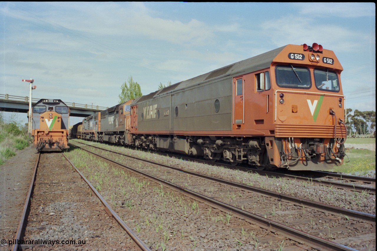 179-25
Gheringhap, V/Line broad gauge goods train 9169 to Adelaide behind G class G 512 Clyde Engineering EMD model JT26C-2SS serial 84-1240 and C classes C 510 Clyde Engineering EMD model GT26C serial 76-833 and C 509 serial 76-832 powers away on the Maroona Line bound for Dimboola and Adelaide, while X class X 51 Clyde Engineering EMD model G26C serial 75-798 is stowed in Siding C, the Ballarat Line is in-between the loco and train.
Keywords: G-class;G512;Clyde-Engineering-Rosewater-SA;EMD;JT26C-2SS;84-1240;