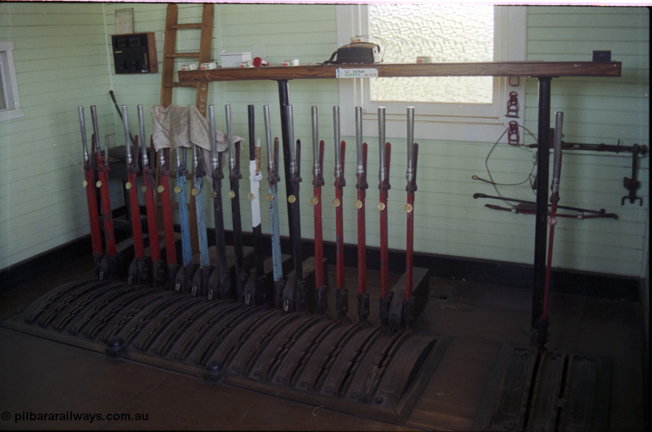 179-31
Gheringhap, internal view of signal box showing the new from 1907 18 lever frame, installed following the removal of double line block to Bannockburn, 2 lever frame extension on the right installed from 1918, lever 11 is painted white, blocked and abolished from 1977. Similarly lever 3 have been removed, most likely when the Maroona line distant was converted to a home signal and signal post 6 was abolished in 1990.
