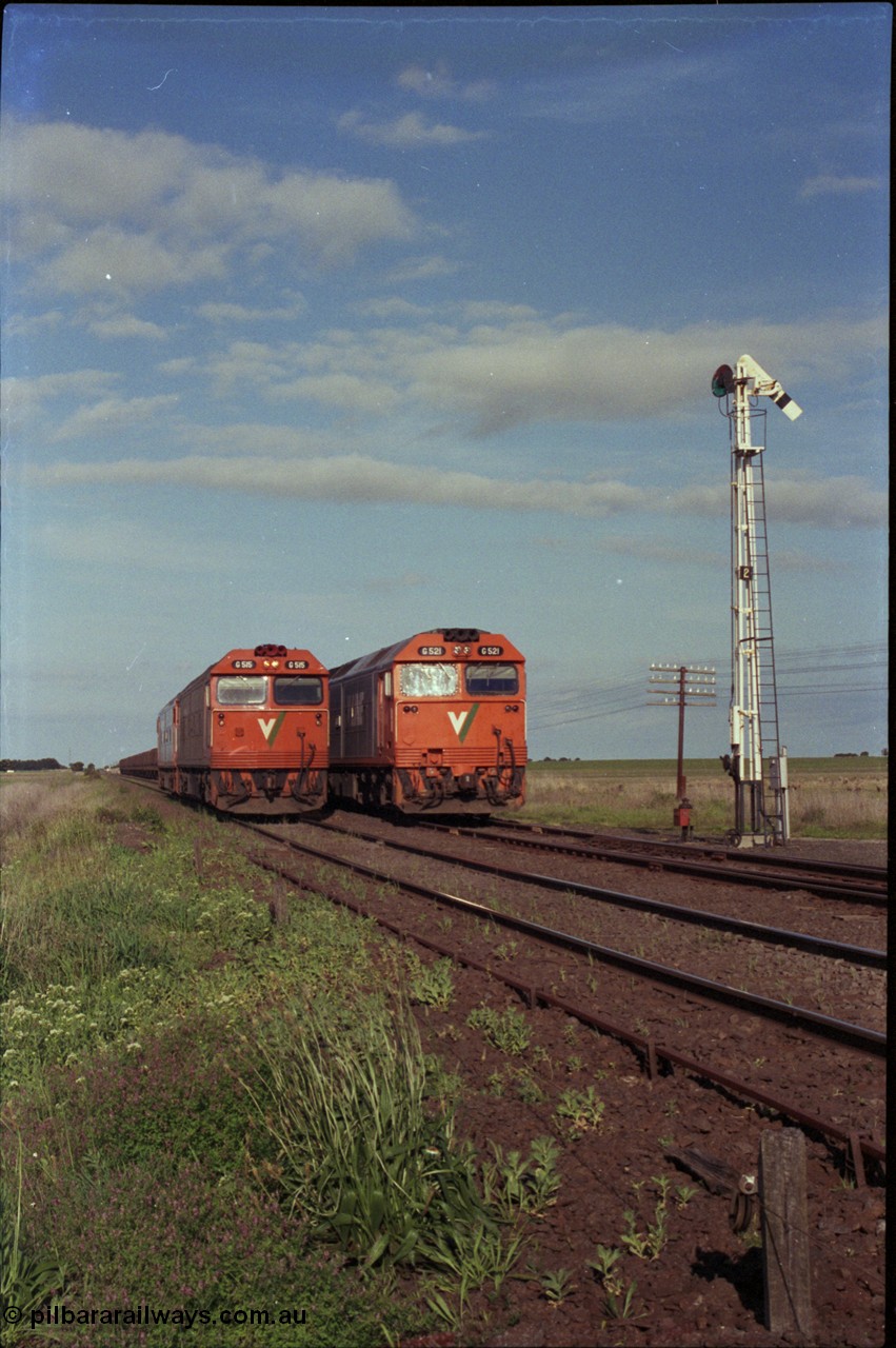 179-34
Gheringhap, track view looking east towards Geelong as broad gauge V/Line light engines G class G 515 Clyde Engineering EMD model JT26C-2SS serial 85-1243 and a sister arrive from North Geelong to recover X 51 pass fellow G class G 521 Clyde Engineering EMD model JT26C-2SS serial 85-1234 locked away with down empty grain train 9121 in Siding A.
Keywords: G-class;G515;Clyde-Engineering-Rosewater-SA;EMD;JT26C-2SS;85-1243;