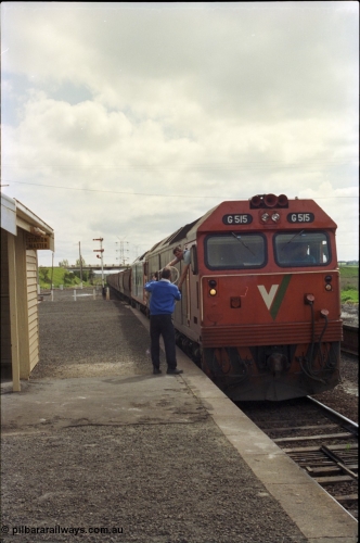 179-10
Gheringhap, V/Line broad gauge G class locomotive G 515 Clyde Engineering EMD model JT26C-2SS serial 85-1243 leads a another G class with up loaded grain train 9122 as the fireman or 2nd person leans out the cab window to swap electric staves with the signaller to continue non-stop to North Geelong gain loop, while Gheringhap is equipped with automatic staff exchange apparatus, they are not used and the G class has no exchanger.
Keywords: G-class;G515;Clyde-Engineering-Rosewater-SA;EMD;JT26C-2SS;85-1243;