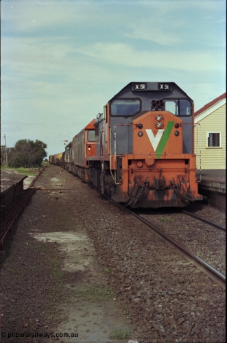 179-15
Gheringhap, V/Line broad gauge X class locomotive X 51 Clyde Engineering EMD model G26C serial 75-798 leads an impressive quad lash-up with G class G 512 Clyde Engineering EMD model JT26C-2SS serial 84-1240 and C classes C 510 Clyde Engineering EMD model GT26C serial 76-833 and C 509 serial 76-832 as they stand at the platform with train number 9169 down goods to Adelaide.
Keywords: X-class;X51;Clyde-Engineering-Rosewater-SA;EMD;G26C;75-798;