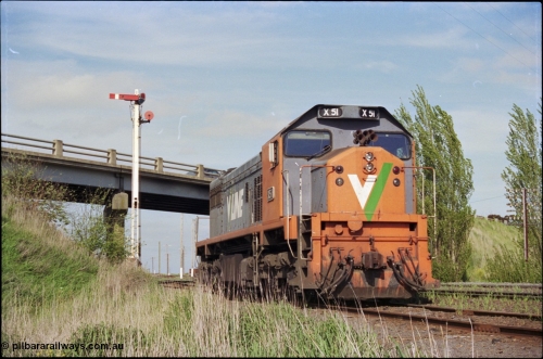 179-28
Gheringhap, Siding C, V/Line broad gauge X class X 51 Clyde Engineering EMD model G26C serial 75-798 sits awaiting some light engines from Geelong Loco to come and retrieve it, semaphore signal post controls up trains on the Ballarat line, while the disc is for Siding C.
Keywords: X-class;X51;Clyde-Engineering-Rosewater-SA;EMD;G26C;75-798;