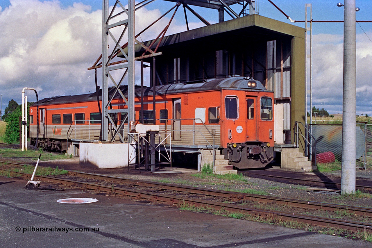 180-04
Seymour loco depot, fuel and sanding point, V/Line broad gauge Tulloch Ltd built DRC class diesel railcar DRC 40 takes on fuel having run a down Saturday morning passenger train from Melbourne.
Keywords: DRC-class;DRC40;Tulloch-Ltd-NSW;