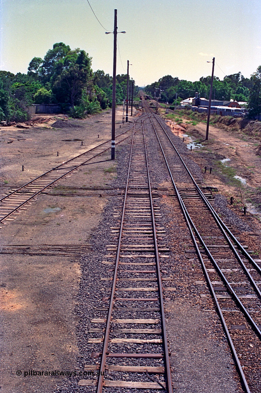 180-11
Wangaratta, rationalised yard view looking north from footbridge, shows steel sleepers in newly extended No.3 Road (originally Siding C) which now joins the mainline in the distance, with the relocated signal post No.23 also just visible, No.4 Road joins in from the left, which was originally 5 Road but 4 Road was also removed along with the sidings that used to be on the left of the image..
