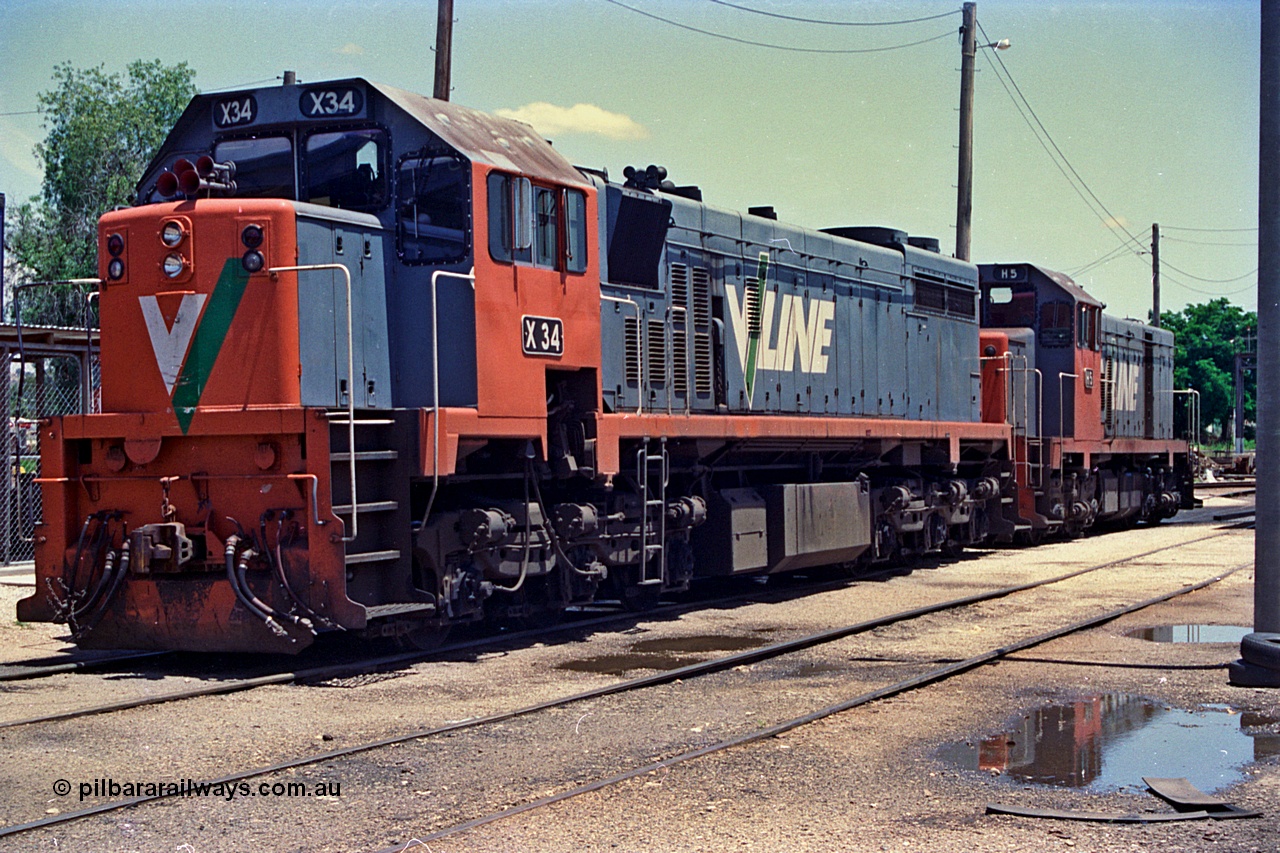 180-35
Wodonga loco depot fuel point, V/Line broad gauge X class X 34 Clyde Engineering EMD model G16C serial 66-487 and H class H 5 Clyde Engineering EMD model G18B serial 68-632 wait to run the Sunday evening up Albury slab steel train.
Keywords: X-class;X34;Clyde-Engineering-Granville-NSW;EMD;G16C;66-487;