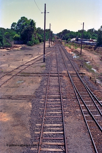 180-11
Wangaratta, rationalised yard view looking north from footbridge, shows steel sleepers in newly extended No.3 Road (originally Siding C) which now joins the mainline in the distance, with the relocated signal post No.23 also just visible, No.4 Road joins in from the left, which was originally 5 Road but 4 Road was also removed along with the sidings that used to be on the left of the image..
