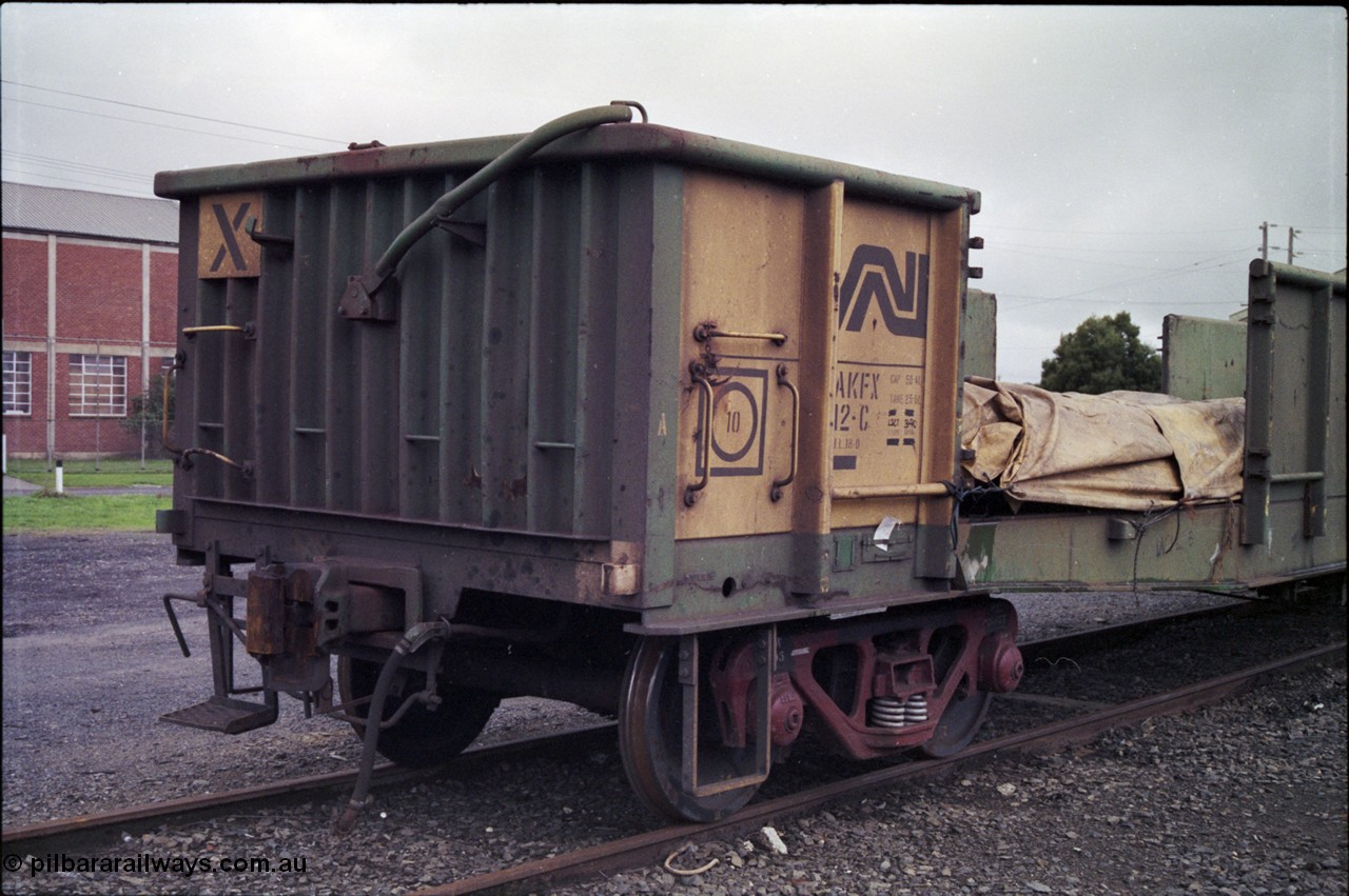 181-09
Trafalgar yard, loaded Australian National AKFX type bogie steel waggon AKFX 12, in AN green and yellow livery, number board view.
Keywords: AKFX-type;AKFX12;