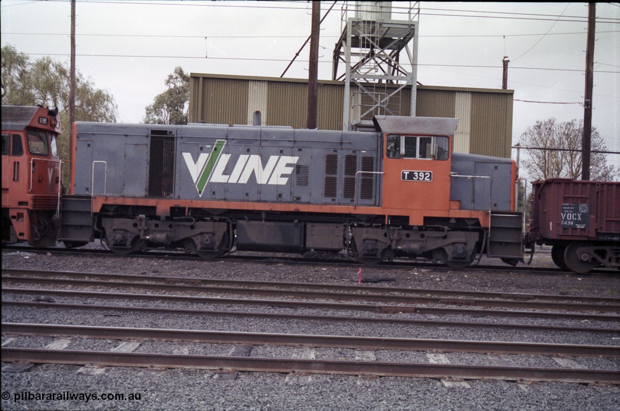 181-11
Traralgon loco depot, V/Line broad gauge loco T class T 392 Clyde Engineering EMD model G8B serial 65-422, side view fuel point and sanding tower behind, coupled to a VOCX type bogie open waggon VOCX 343 and a G class.
Keywords: T-class;T392;Clyde-Engineering-Granville-NSW;EMD;G8B;65-422;