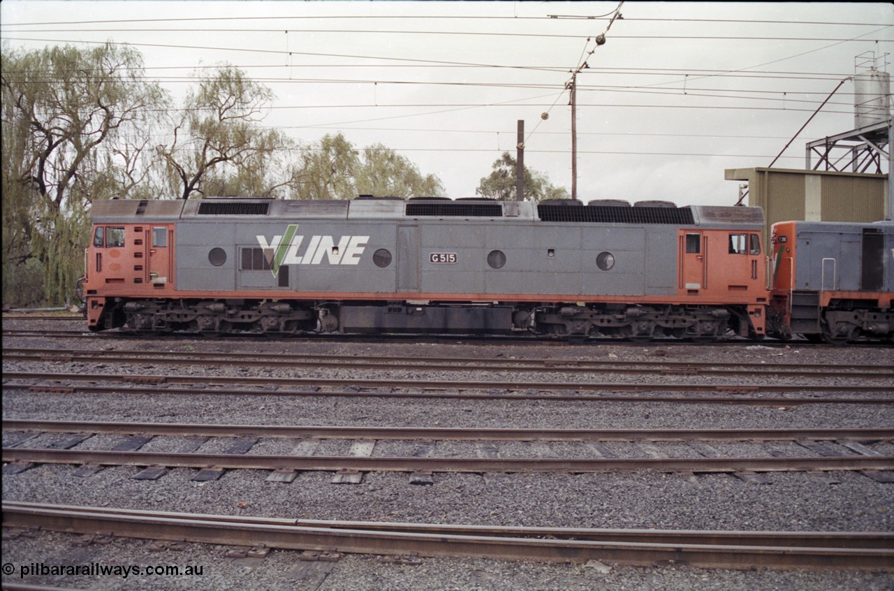 181-12
Traralgon loco depot, V/Line broad gauge loco G class G 515 Clyde Engineering EMD model JT26C-2SS serial 85-1243, side view, coupled to a T class.
Keywords: G-class;G515;Clyde-Engineering-Rosewater-SA;EMD;JT26C-2SS;85-1243;