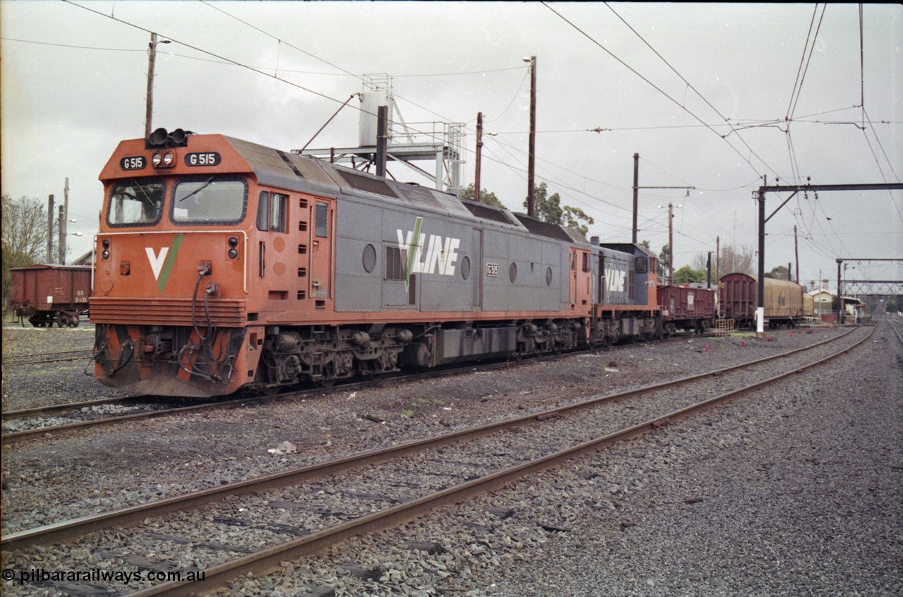 181-14
Traralgon loco depot and station overview, V/Line broad gauge locos G class G 515 Clyde Engineering EMD model JT26C-2SS serial 85-1243 and T class T 392 Clyde Engineering EMD model G8B serial 65-422 along with VOCX type bogie open waggon VOCX 343 and a VFNX type tarpaulin waggon, station building in background.
Keywords: G-class;G515;Clyde-Engineering-Rosewater-SA;EMD;JT26C-2SS;85-1243;