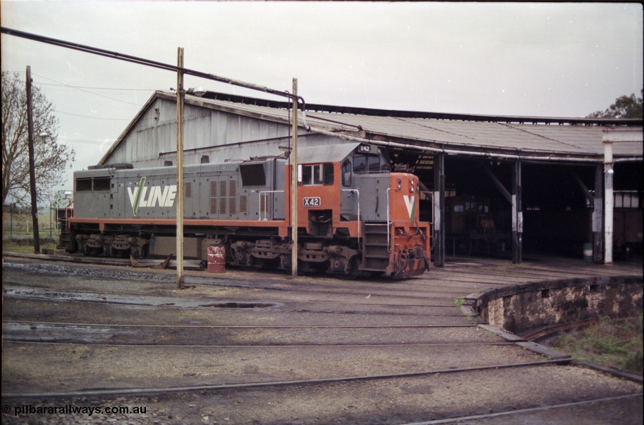 181-18
Traralgon loco depot view of turntable roads, edge of pit and roundhouse with X class X 42 Clyde Engineering EMD model G26C serial 70-705, a yellow RT class rail tractor can be seen in the roundhouse.
Keywords: X-class;X42;Clyde-Engineering-Granville-NSW;EMD;G26C;70-705;