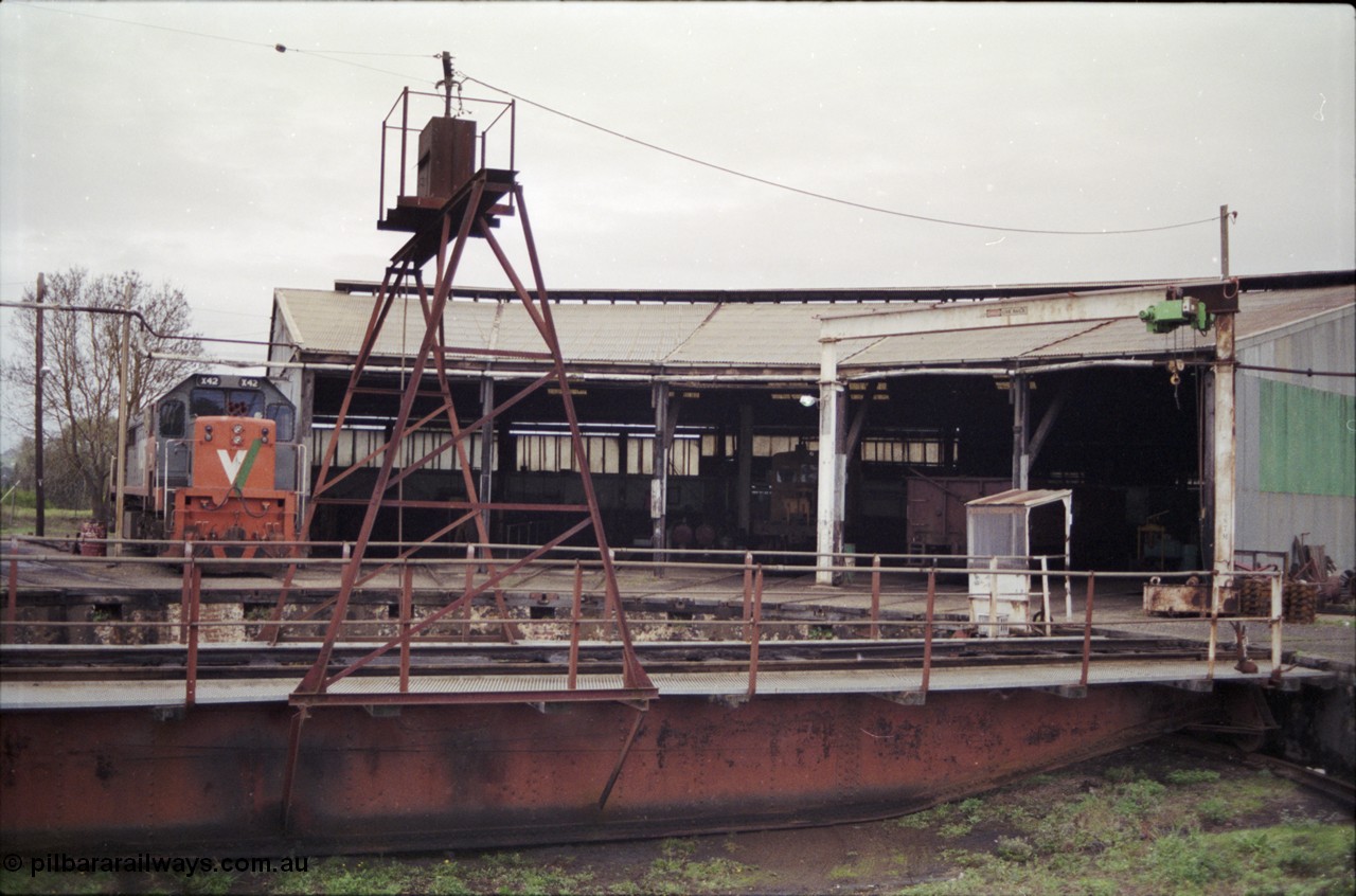 181-19
Traralgon loco depot roundhouse and turntable overview, X class X 42 Clyde Engineering EMD model G26C serial 70-705, turntable and pit, 5 stall round house with RT class rail tractor and a bogie open waggon, gantry crane at right.
Keywords: X-class;X42;Clyde-Engineering-Granville-NSW;EMD;G26C;70-705;