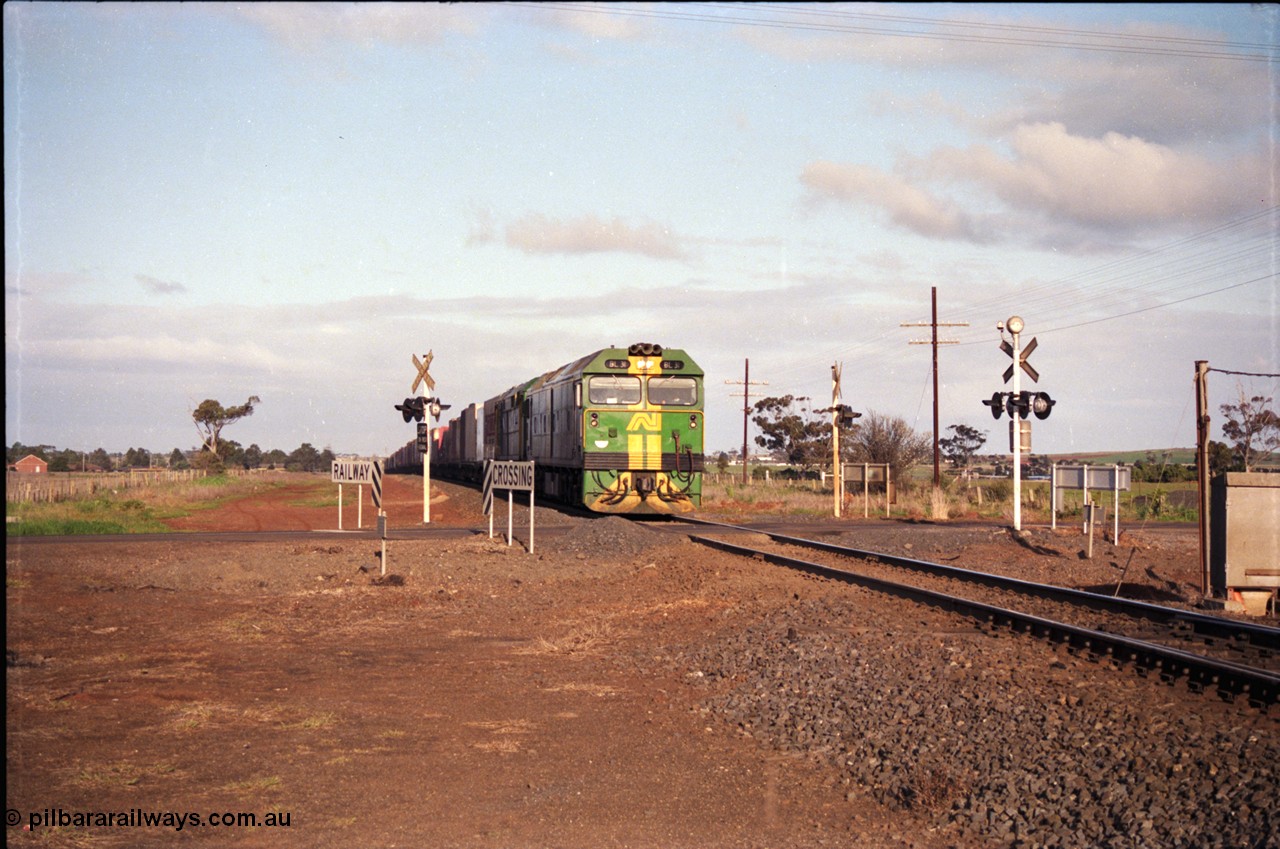 183-05
Rockbank, an Adelaide bound down broad gauge goods train behind Australian National BL class BL 31 Clyde Engineering EMD model JT26C-2SS serial 83-1015 and 700 class 705 AE Goodwin ALCo model DL500G serial G6059-3 at the grade crossing for Station Road.
Keywords: BL-class;BL31;Clyde-Engineering-Rosewater-SA;EMD;JT26C-2SS;83-1015;