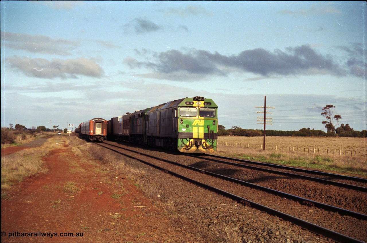 183-08
Rockbank, an Adelaide bound down broad gauge goods train behind Australian National BL class BL 31 Clyde Engineering EMD model JT26C-2SS serial 83-1015 and 700 class 705 AE Goodwin ALCo model DL500G serial G6059-3 as an up V/Line passenger train runs through on the loop.
Keywords: BL-class;BL31;Clyde-Engineering-Rosewater-SA;EMD;JT26C-2SS;83-1015;