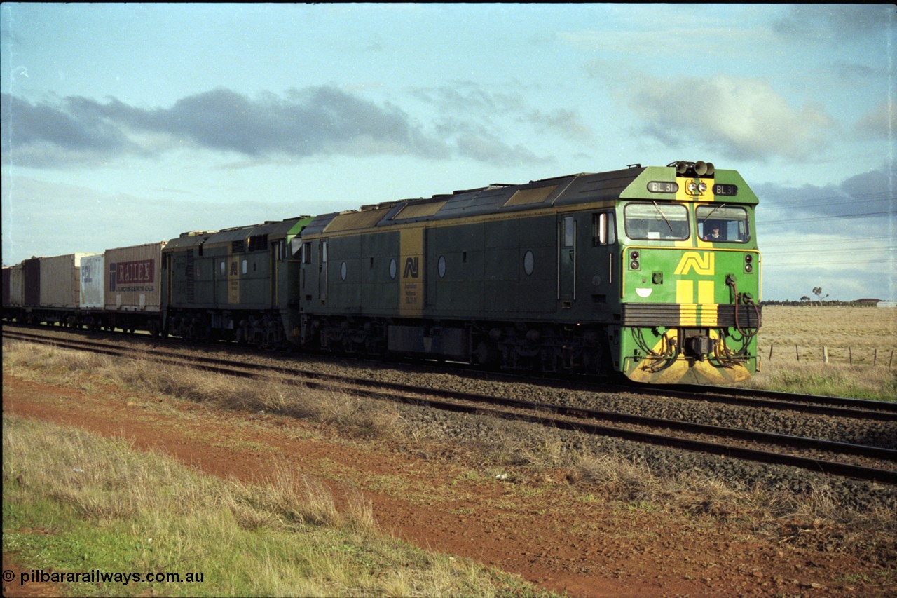 183-09
Rockbank, an Adelaide bound down broad gauge goods train behind Australian National BL class BL 31 Clyde Engineering EMD model JT26C-2SS serial 83-1015 and 700 class 705 AE Goodwin ALCo model DL500G serial G6059-3 stands on the mainline having had an up passenger train cross it.
Keywords: BL-class;BL31;Clyde-Engineering-Rosewater-SA;EMD;JT26C-2SS;83-1015;