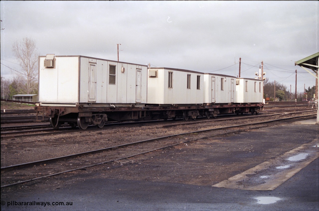 183-16
Benalla, yard view, V/Line broad gauge VQCX type 60 foot bogie container waggons VQCX 968 which was built new by Victorian Railways Ballarat North Workshops in April 1980 and another loaded with workman's dongers, or accommodation blocks, the yard is being rationalised.
Keywords: VQCX-type;VQCX968;Victorian-Railways-Ballarat-Nth-WS;