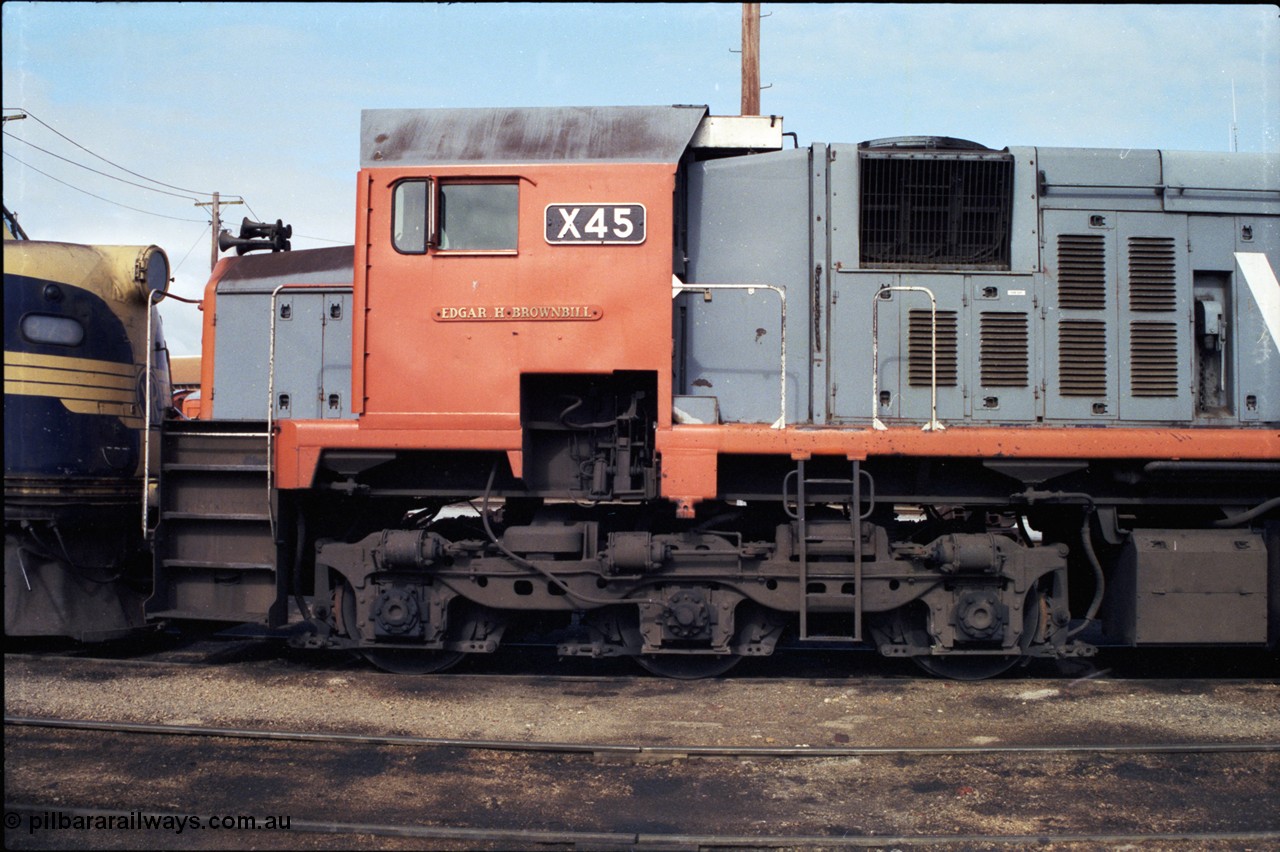 183-22
Wodonga loco depot fuel point, V/Line broad gauge X class loco X 45 'Edgar H Brownbill' Clyde Engineering EMD model G26C serial 75-792, cab side view of name and number board, bogie and staff exchanger.
Keywords: X-class;X45;Clyde-Engineering-Rosewater-SA;EMD;G26C;75-792;