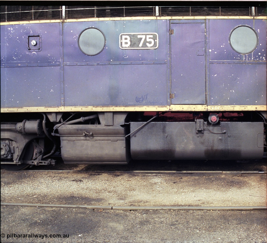 183-26
Wodonga loco depot fuel point, V/Line broad gauge Bulldog B class locomotive B 75 Clyde Engineering EMD model ML2 serial ML2-16 still in Victorian Railways livery, side view of battery box and fuel tank.
Keywords: B-class;B75;Clyde-Engineering-Granville-NSW;EMD;ML2;ML2-16;bulldog;