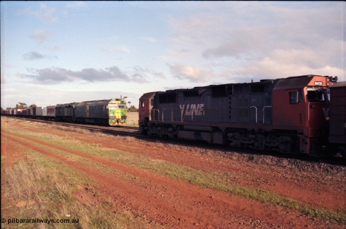 183-07
Rockbank, V/Line broad gauge N class N 472 'City of Sale' Clyde Engineering EMD model JT22HC-2 serial 87-1201 runs along the loop with an up passenger train while down Adelaide bound goods train behind Australian National locomotives BL class BL 31 Clyde Engineering EMD model JT26C-2SS serial 83-1015 and 700 class 705 AE Goodwin ALCo model DL500G serial G6059-3 stands on the mainline.
Keywords: N-class;N472;Clyde-Engineering-Somerton-Victoria;EMD;JT22HC-2;87-1201;