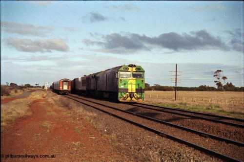183-08
Rockbank, an Adelaide bound down broad gauge goods train behind Australian National BL class BL 31 Clyde Engineering EMD model JT26C-2SS serial 83-1015 and 700 class 705 AE Goodwin ALCo model DL500G serial G6059-3 as an up V/Line passenger train runs through on the loop.
Keywords: BL-class;BL31;Clyde-Engineering-Rosewater-SA;EMD;JT26C-2SS;83-1015;