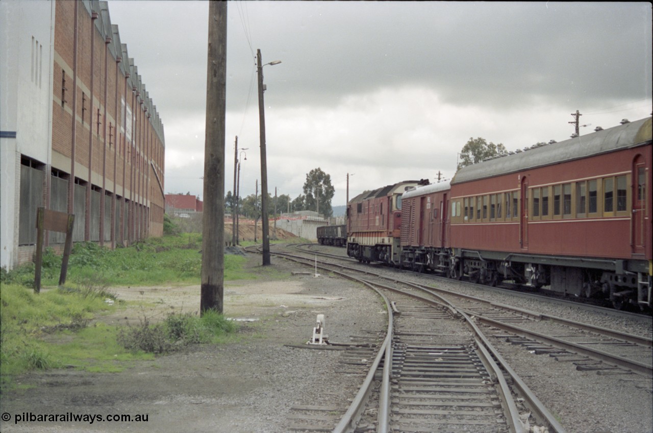 184-03
Albury station yard, standard gauge NSWSRA 81 class 8161 Clyde Engineering EMD model JT26C-2SS serial 84-1080 in candy livery leads a special 'Phantom of the Opera' passenger train bound for Sydney, trailing view, the old Dalgety's building is at left.
Keywords: 81-class;8161;Clyde-Engineering-Kelso-NSW;EMD;JT26C-2SS;84-1080;