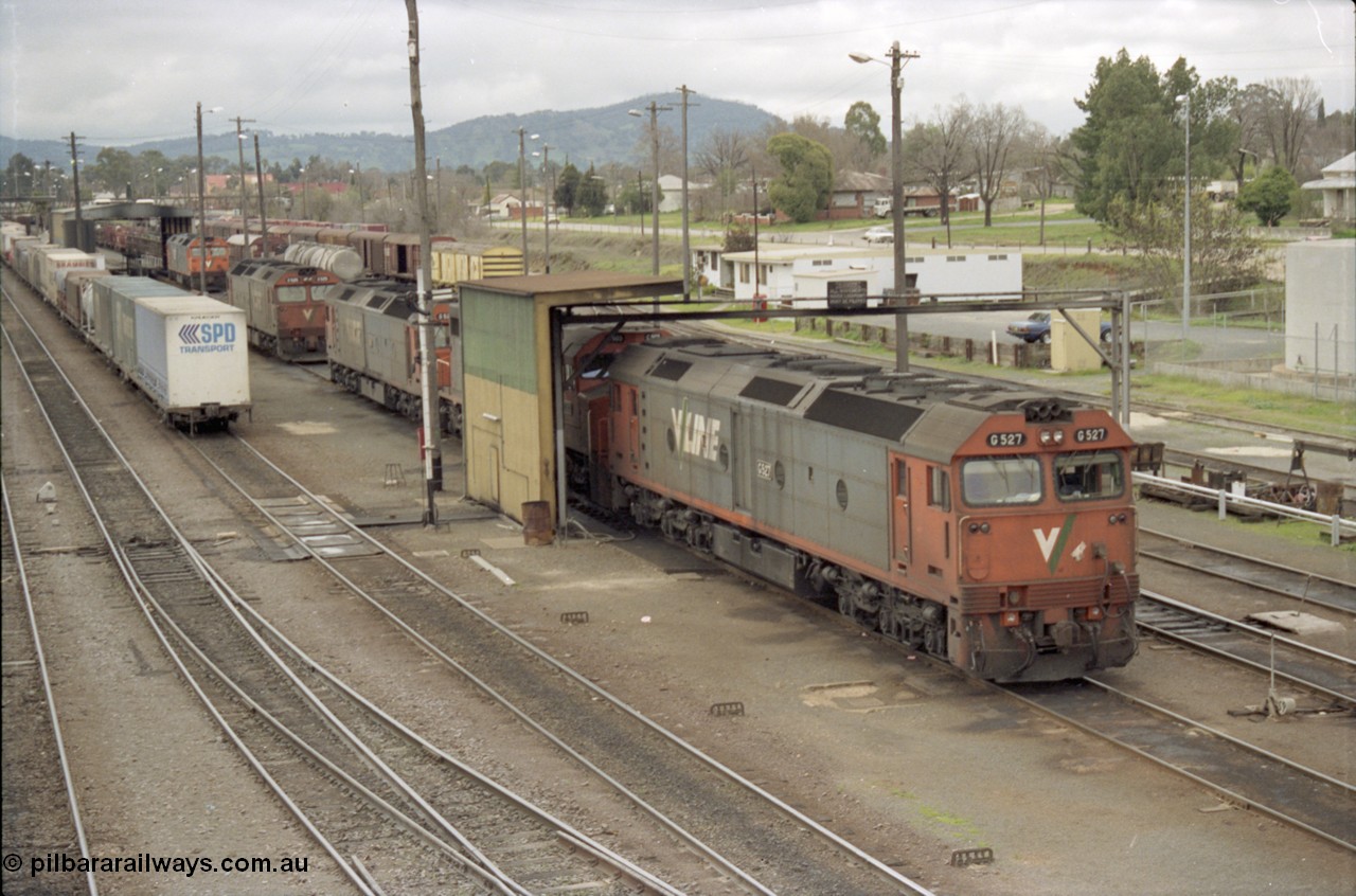 184-07
Albury loco depot fuel point, V/Line standard gauge locos lined up awaiting the Sunday run of goods trains back to Melbourne, G class G 527 Clyde Engineering EMD model JT26C-2SS serial 88-1257, C class C 503 Clyde Engineering EMD model GT26C serial 76-826 and G classes G 520 serial 85-1233, G 525 serial 86-1238 and G 523 serial 86-1236, the SPD container is on stabled train SM5, elevated view.
Keywords: G-class;G527;Clyde-Engineering-Somerton-Victoria;EMD;JT26C-2SS;88-1257;C-class;C503;GT26C;76-826;G520;85-1233;G525;86-1238;G523;86-1236;