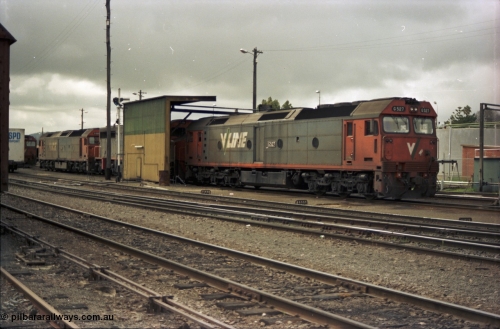 184-01
Albury loco depot fuel point, V/Line standard gauge locos lined up awaiting the Sunday run of goods trains back to Melbourne, G class G 527 Clyde Engineering EMD model JT26C-2SS serial 88-1257, C class C 503 Clyde Engineering EMD model GT26C serial 76-826 and G classes G 520 serial 85-1233 and partly obscured G 525 serial 86-1238, semaphore signal and rear of fuel point, view across yard, point rodding.
Keywords: G-class;G527;Clyde-Engineering-Somerton-Victoria;EMD;JT26C-2SS;88-1257;C-class;C503;GT26C;76-826;G520;85-1233;G525;86-1238;