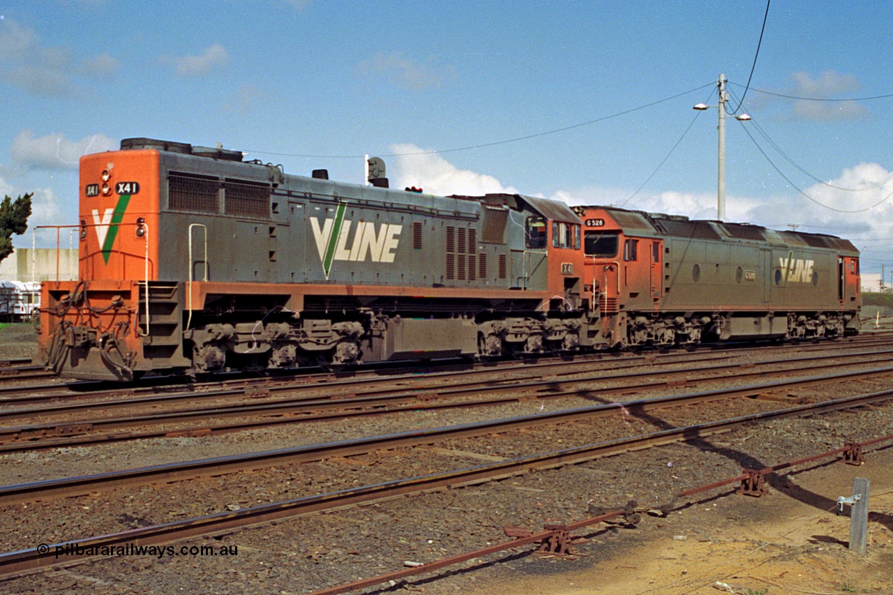 185-15
North Geelong Yard, V/Line grain loop shunt engines X class locomotive X 41 Clyde Engineering EMD model G26C serial 70-704 long end leading and G class locomotive G 528 Clyde Engineering EMD model JT26C-2SS serial 88-1258 stand in the yard awaiting the road to the arrivals to collect another loaded grain consist.
Keywords: X-class;X41;Clyde-Engineering-Granville-NSW;EMD;G26C;70-704;